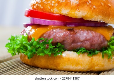 Delicious Tasty Hamburger With Pork Patty, Fresh Vegetables And Cheese At Plate