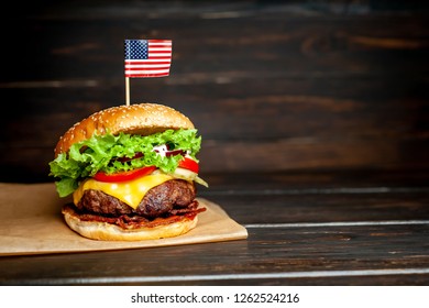 delicious tasty homemade burger with american flag for slicing beef on wooden table - Powered by Shutterstock