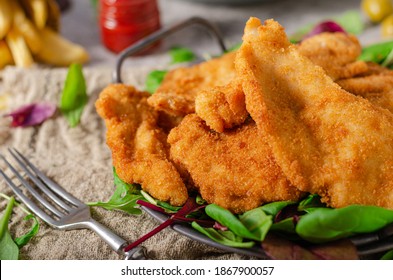 Delicious tender chicken chnitzel with homemade french-fries