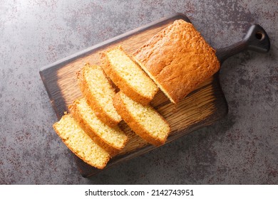 Delicious tender Madeira biscuit cake close-up on a wooden board on the table. horizontal top view from  above