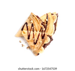 Delicious Thin Pancakes With Chocolate Spread, Banana And Nuts On White Background, Top View