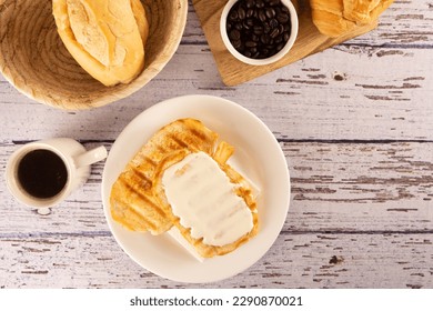 Delicious toasted bread with melted butter and cream cheese, Coffee, Brazilian breakfast - Powered by Shutterstock