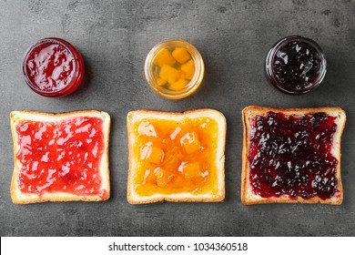 Delicious toasts with various sweet jams on grey background - Powered by Shutterstock