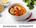 Delicious tom yum soup with seafood, vietnamese soup, thai cuisine, spicy seafood soup, cuisine on a beautiful restaurant background, tom yum soup in a beautiful plate