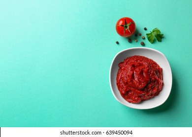 Delicious Tomato Paste In Bowl On Color Background, Closeup