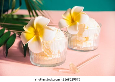 Delicious tropical flavors ice cream sorbet sundae decorated flower plumeria frangipani and palm leaf on the background . Summer food concept - Powered by Shutterstock