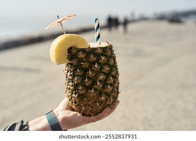 Delicious Tropical Pineapple Drink garnished with a colorful Umbrella and a Banana Slice - Powered by Shutterstock