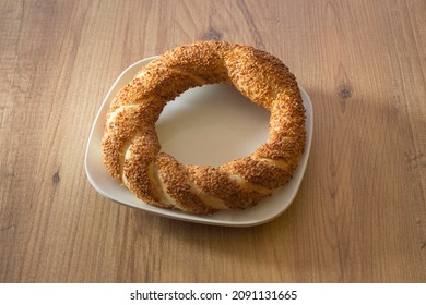 A Delicious Turkish Simit On White Plate. Turkish Breakfast. A Fresh Sesame Simit On White Plate.