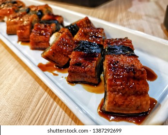 Delicious Unagi Eel Nigiri Sushi (Eel Sushi) on white plate. Traditional Japanese cuisine. Close up of Unagi Sushi Set Japan eel.