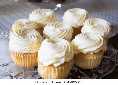 Delicious Vanilla Cupcakes with Creamy Swirl Frosting on a Decorative Plate - Powered by Shutterstock