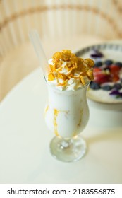 Delicious Vanilla Milkshake Covered With Whipped Cream And Some Biscuit  In Glass ,close Up 