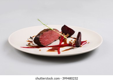 Delicious veal fillet served with sauce, molecular froth and beetroot - Shutterstock ID 399480232