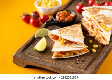 Delicious vegetarian quesadilla with tomato, baked beans and corn on yellow background, closeup view - Powered by Shutterstock