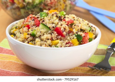 Delicious vegetarian quinoa salad with bell pepper, cucumber and tomatoes (Selective Focus, Focus one third into the bowl)