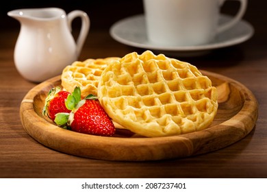 Delicious waffles. Plate with baked waffles on the table.