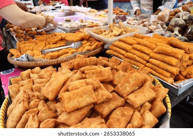 Delicious and warm stuffed risoles are being sold at a traditional snack stall. Risoles is a traditional Indonesian food that can be filled with chicken, vegetables, meat, corn, and mayonnaise.
