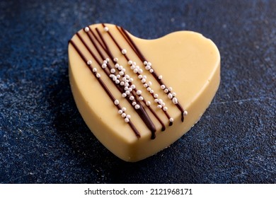 Delicious White Chocolate Heart On Blue Rustic Table.