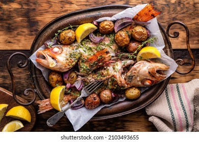 Delicious Whole Baked Redfish With Chimichurri Sauce, Baby Potatoes, Red Onion, Lemon And Thyme.