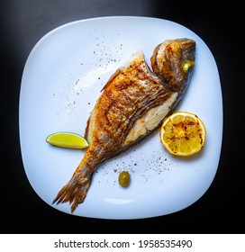 Delicious Whole Sea Bass Fish Cooked On Grill For Dinner In Seafood Restaurant,shot In Flat Lay Style On Table.Download Royalty Free Curated Images Collection With Foods For Design Template