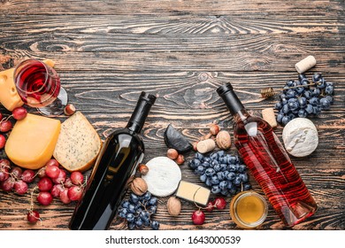 Delicious wine with snacks on wooden background - Shutterstock ID 1643000539