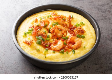 Delicious yellow grits with cheese, shrimps and bacon close-up in a plate on the table. horizontal - Shutterstock ID 2109033137