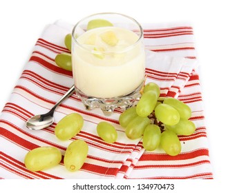 Delicious yogurt in glass with grapes isolated on white