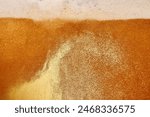 Delicious-looking beer poured into glass. Beer pale golden color and has thick, white head of foam. Textured photo. Abstract background. Concept of refreshing alcohol drink, Oktoberfest, summer, party