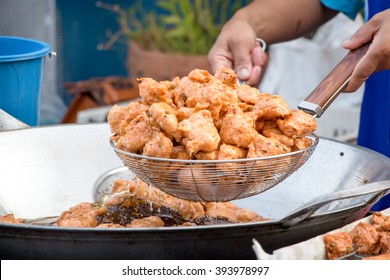 A Delicious-looking Spicy Fried Food Or Fried Fish Patty From A Boiling Pan Of A Roadside Food Stall In Thailand