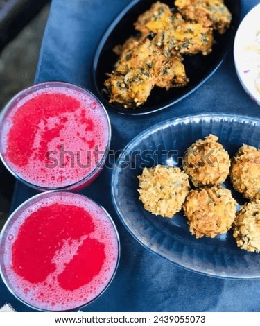 Deliciously fried chickpea fritters, paired with a refreshing splash of strawberry, create a harmonious blend of savory and sweet flavors, tantalizing the taste buds with each delightful bite. [[stock_photo]] © 