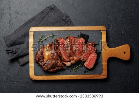 Deliciously juicy sliced beef ribeye steak, perfectly cooked and ready to be savored. Flat lay