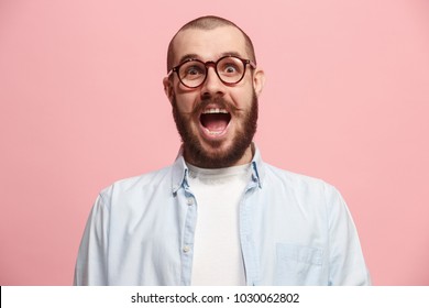 Delight. Beautiful Male Half-length Front Portrait Isolated On Pink Studio Backgroud. Young, Emotional, Smiling, Surprised Man Standing. Human Emotions, Facial Expression Concept. Trendy Colors