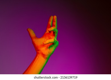 Delight. Studio Shot Of Authentic Human Hands Isolated On Purple Studio Background In Neon Light. Concept Of Human Relation, Community, Art, Symbolism, Culture, And History