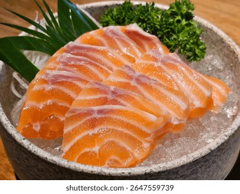 Delight in this vibrant image of fresh salmon sashimi served on ice, garnished with herbs. Perfect for showcasing culinary art in food photography.