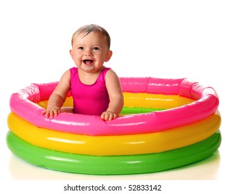 A Delighted Baby Girl Playing In A Water-filled Kiddie Pool.  Isolated On White.