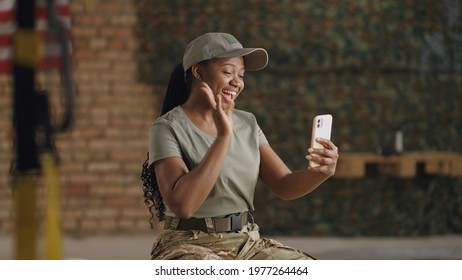 Delighted black military woman speaking with online friend
