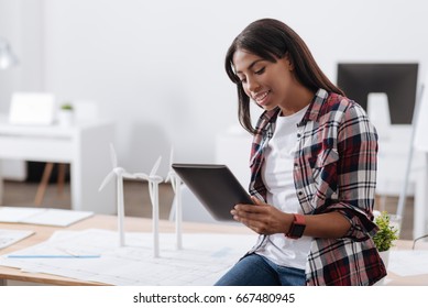 Delighted environmental engineer holding a tablet