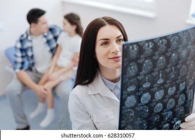 Delighted Female Doctor Looking At The X Ray Scan Image