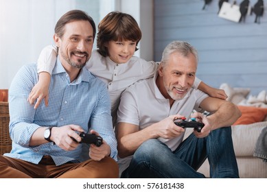 Delighted happy men playing video games - Powered by Shutterstock