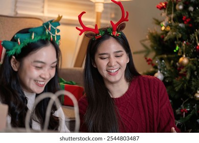 Delighted Lesbian Friends Embracing Holiday Spirit with Festive Laughs - Powered by Shutterstock