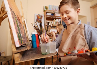 Delighted Little Boy Having Art Lesson At School