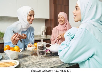 Delighted Muslim Women Laughing In The Kitchen