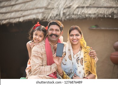 Delighted Rural Family Holding New Mobile Phone