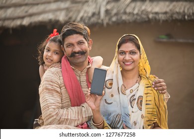 Delighted Rural Family Holding New Mobile Phone