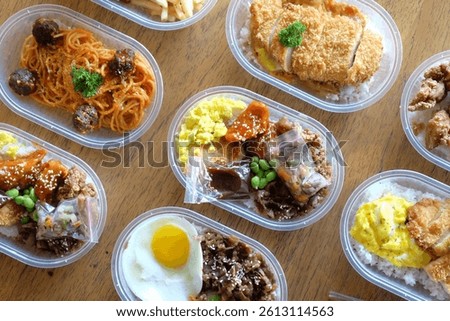 A delightful array of bento boxes showcases diverse Asian-inspired dishes.  Savory meats, colorful veggies, and fluffy rice create a visually appealing and tasty meal.