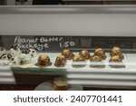 A delightful display of homemade peanut butter buckeyes in a bakery showcase, featuring an enticing assortment of these irresistible treats. 