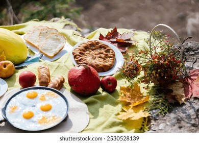 A delightful picnic spread awaits by the riverside, showcasing freshly cooked eggs, baked goods, apples, and autumn foliage under warm sunlight, inviting relaxation and enjoyment. - Powered by Shutterstock