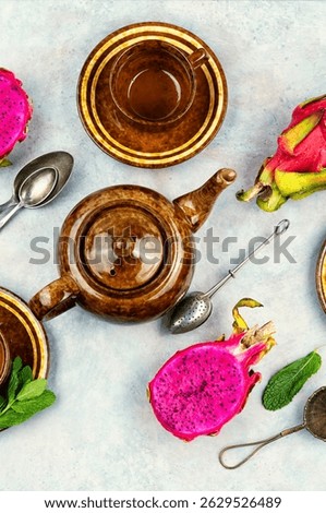 Delightfully brewed dragon fruit tea served with raw pitaya.