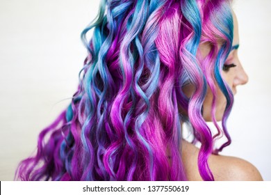 Delightfully bright colored hair  multi  colored coloring long hair  The stylish  contemporary styling curls  Attractive young woman and stylish hair coloring