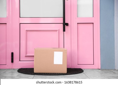 Delivered parcel on door mat near entrance