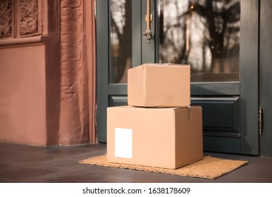 Delivered parcels on door mat near entrance - Shutterstock ID 1638178609